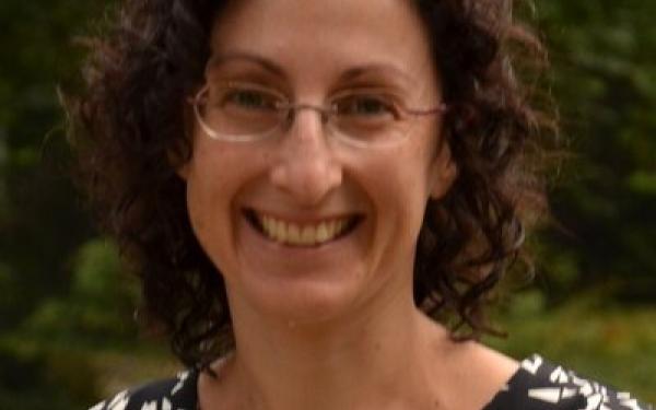 Woman with dark hair and glasses, smiling (Naomi Brenner)