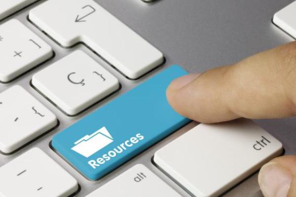Human finger pressing on a Resources key on a keyboard